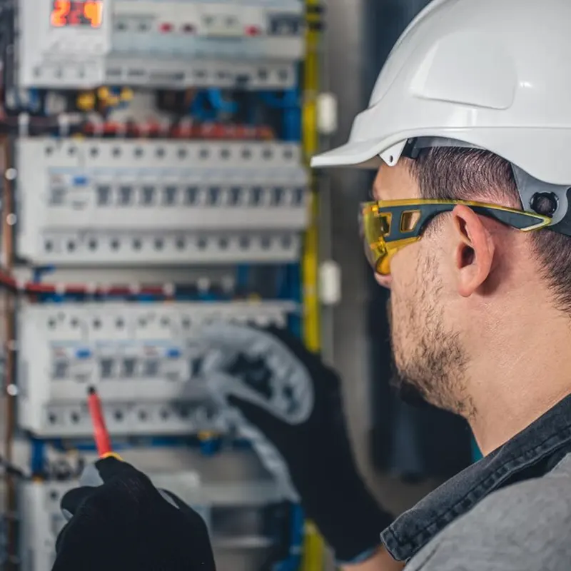 A commercial electrician in Jersey doing a wiring inspection