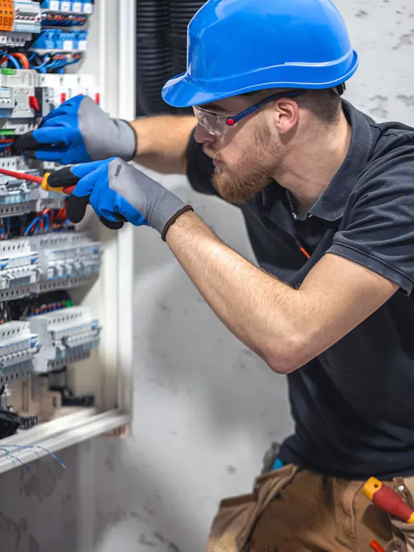 A local electrician working on an electrical panel in Jersey.
