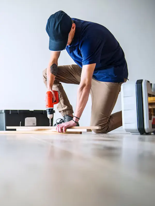 An expert floor carpenter in jersey doing an emergency floor repair.