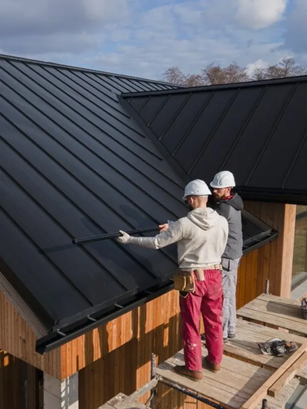 Emergency roofer in St. Helier Jersey repairing a residential roof.