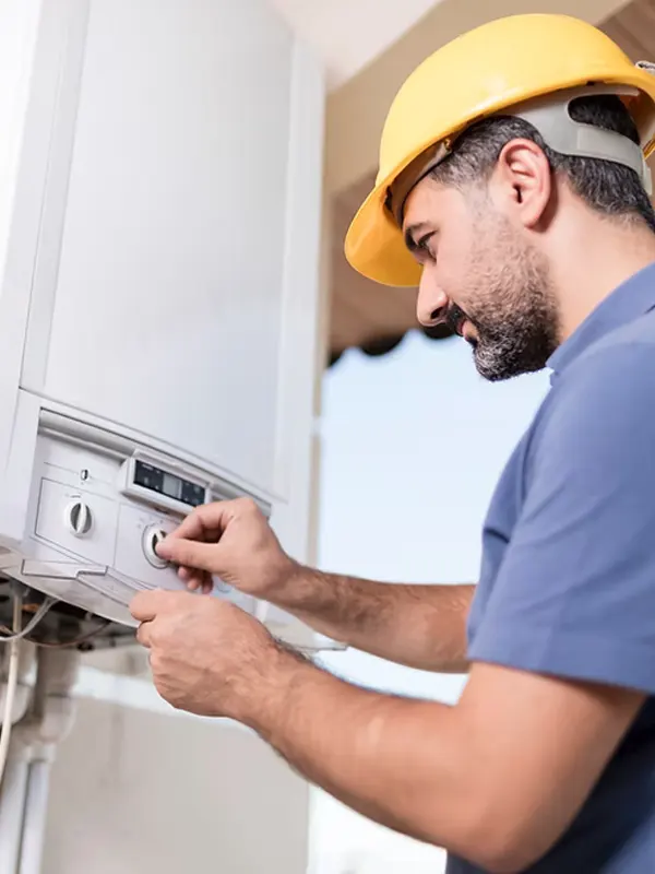 A professional boiler engineer adjusting a gas boiler in Jersey for maintenance and servicing to ensure efficient heating.