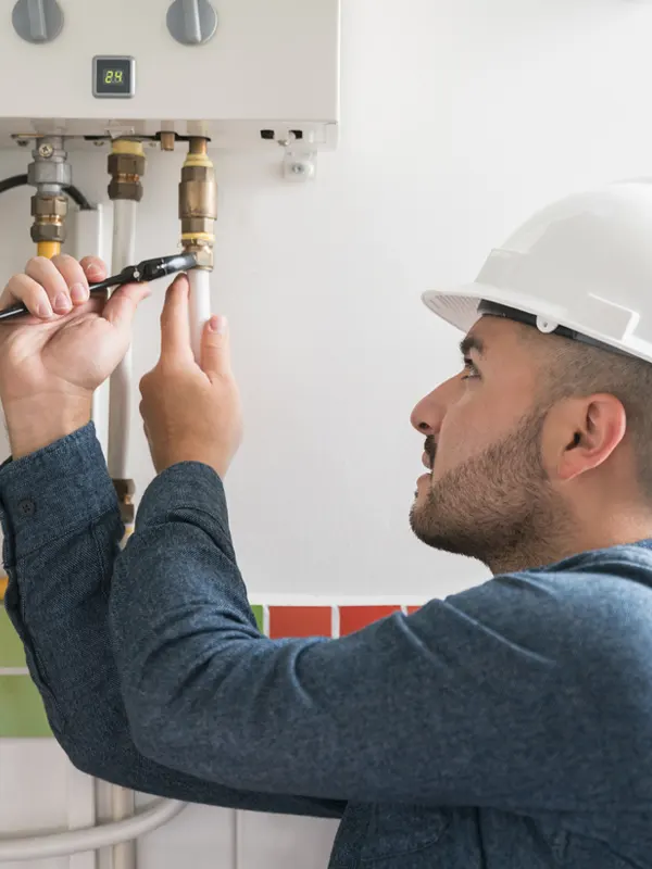 An elocal emergency boiler repair technician fixing a heating system to restore hot water and home heating in Jersey.