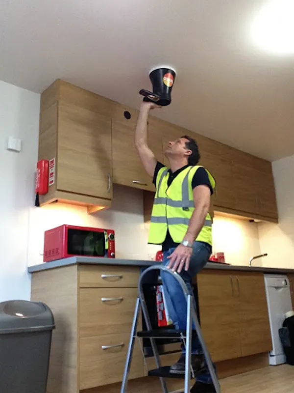 An extractor fan installer in Jersey doing a repair in a Jersey home.