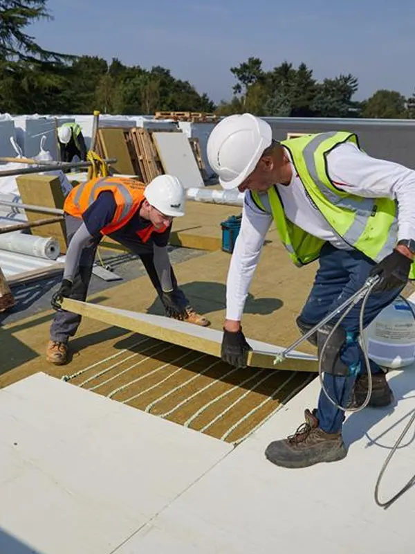 The top-rated roof tradesmen in Jersey doing a flat roof service in a Jersey home.