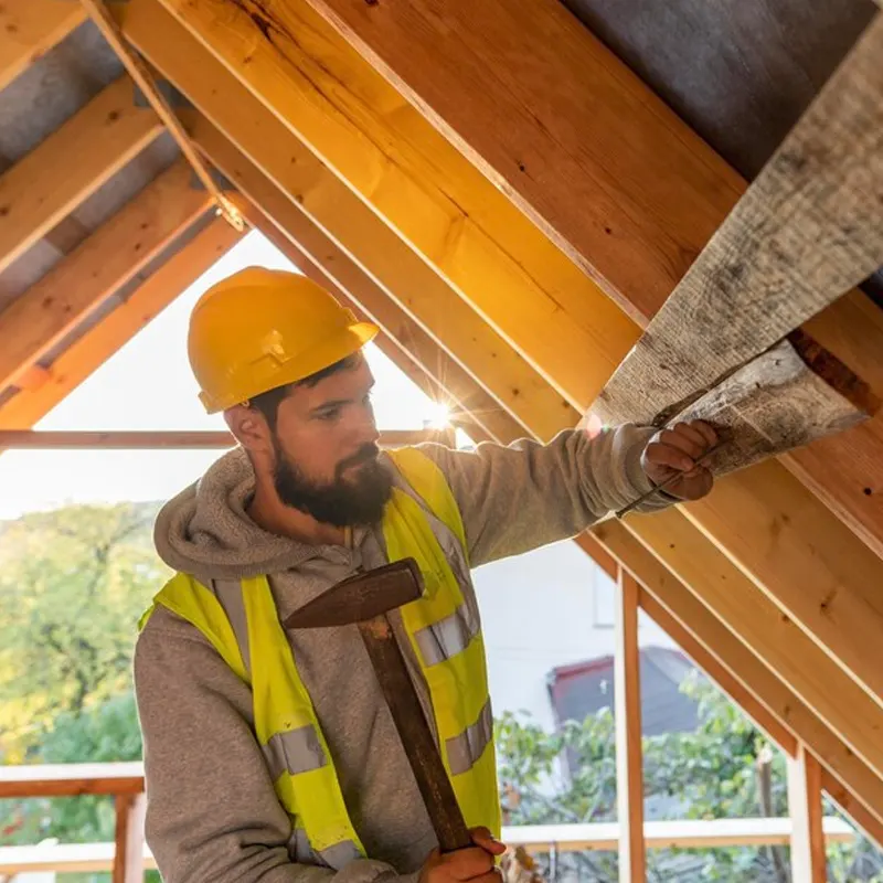 An expert roof tradesmen doing a roof service in a Jersey home.