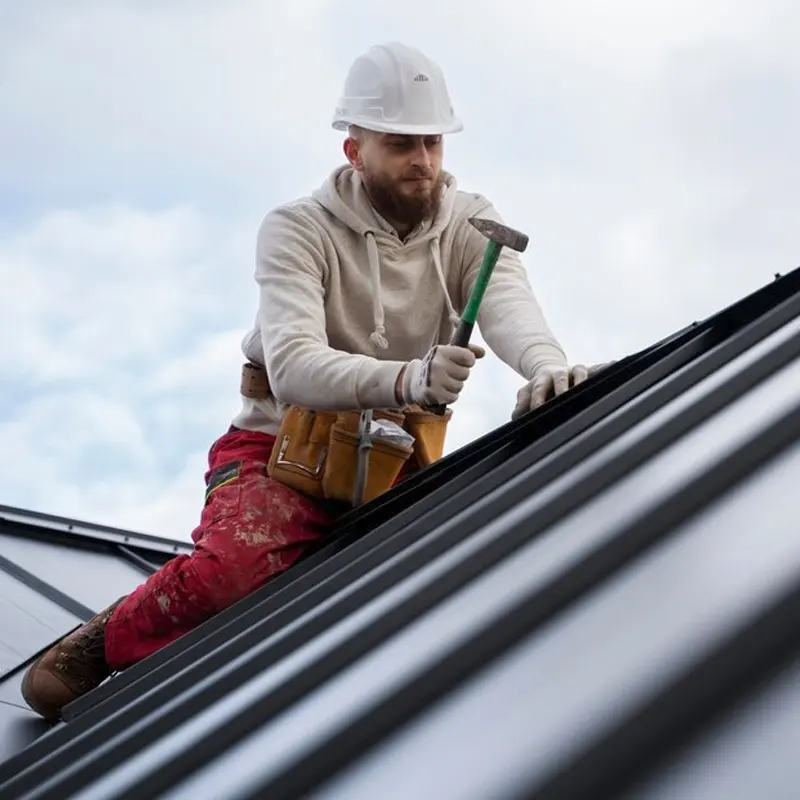 An expert roofer in Jersey doing a roof repair and service in a residential roof.